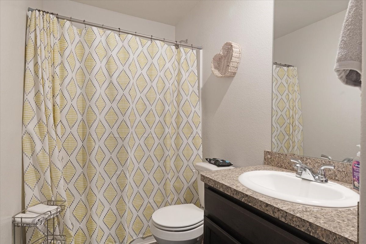 1685 County Road 5102 East Cleveland, TX 77327 - Photo 21 of 31 a bathroom with a granite countertop sink and a mirror