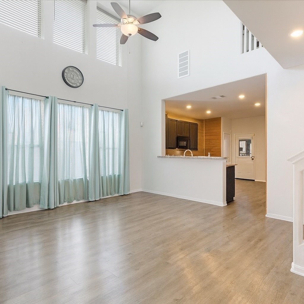 1685 County Road 5102 East Cleveland, TX 77327 - Photo 7 of 31 a view of an empty room with wooden floor and a window