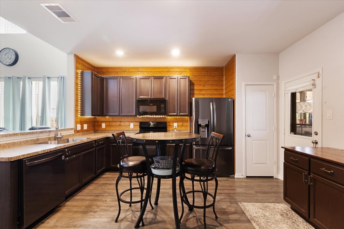1685 County Road 5102 East Cleveland, TX 77327 - Photo 10 of 31 a kitchen with a sink and chairs