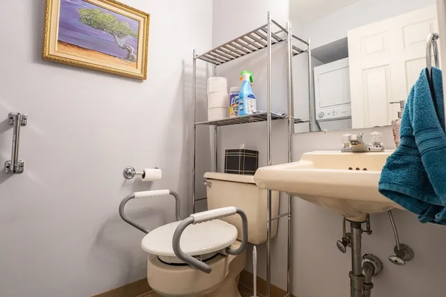 a bathroom with a sink toilet and mirror