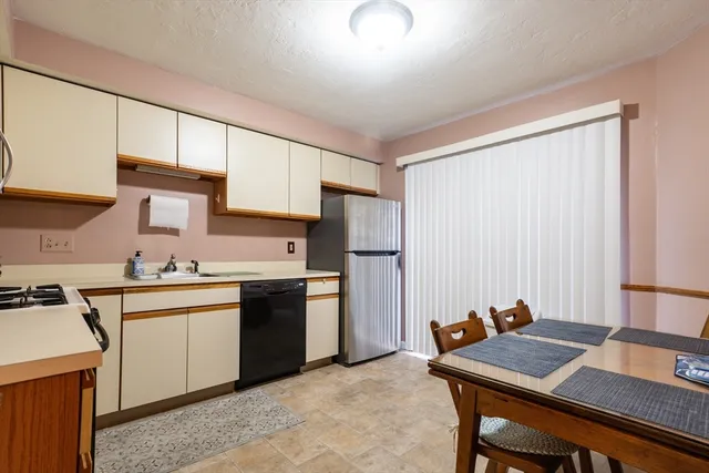 a kitchen with stainless steel appliances granite countertop a stove refrigerator sink and cabinets