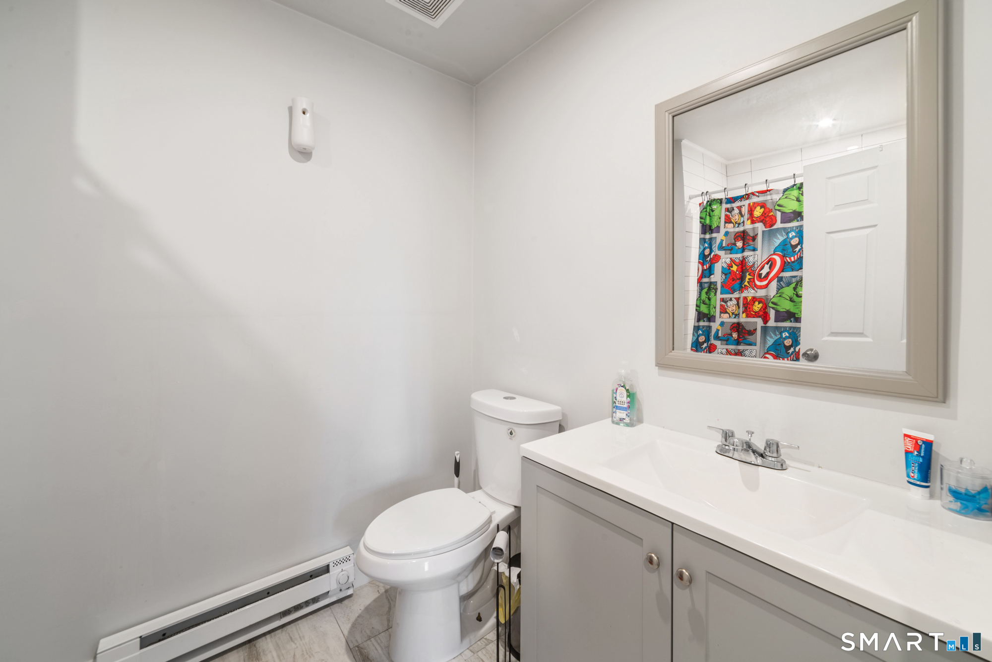 327 Lakeside Boulevard West Waterbury, CT 06708 - Photo 17 of 29 a bathroom with a sink mirror vanity and toilet