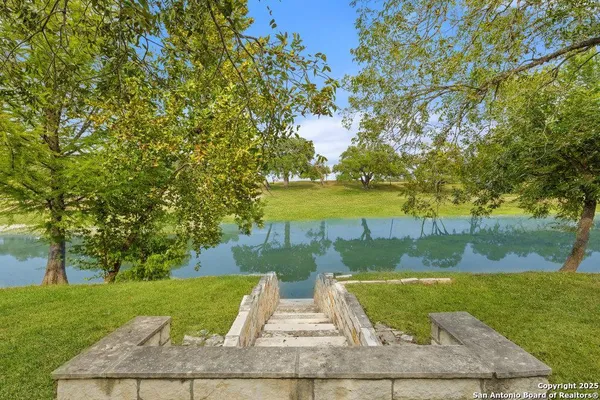a view of a yard and swimming pool