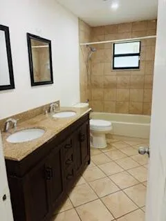 a bathroom with a double vanity sink toilet and shower