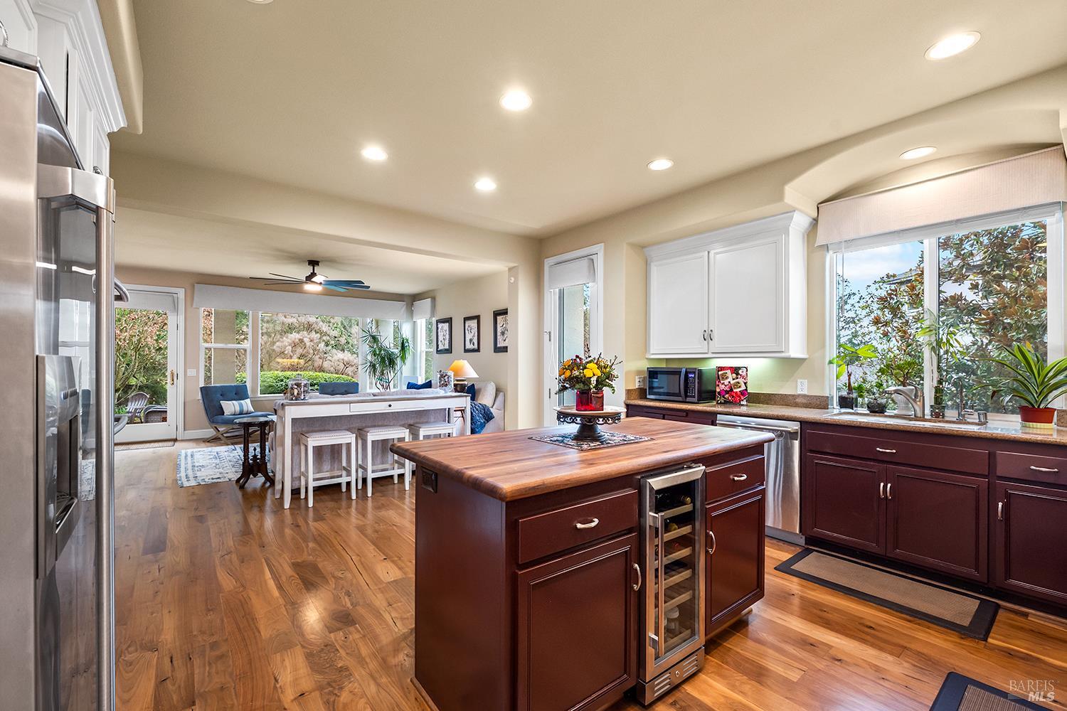3696 Newbury Court Santa Rosa, CA 95404 - Photo 9 of 52 a kitchen that has a sink a table and chairs in it