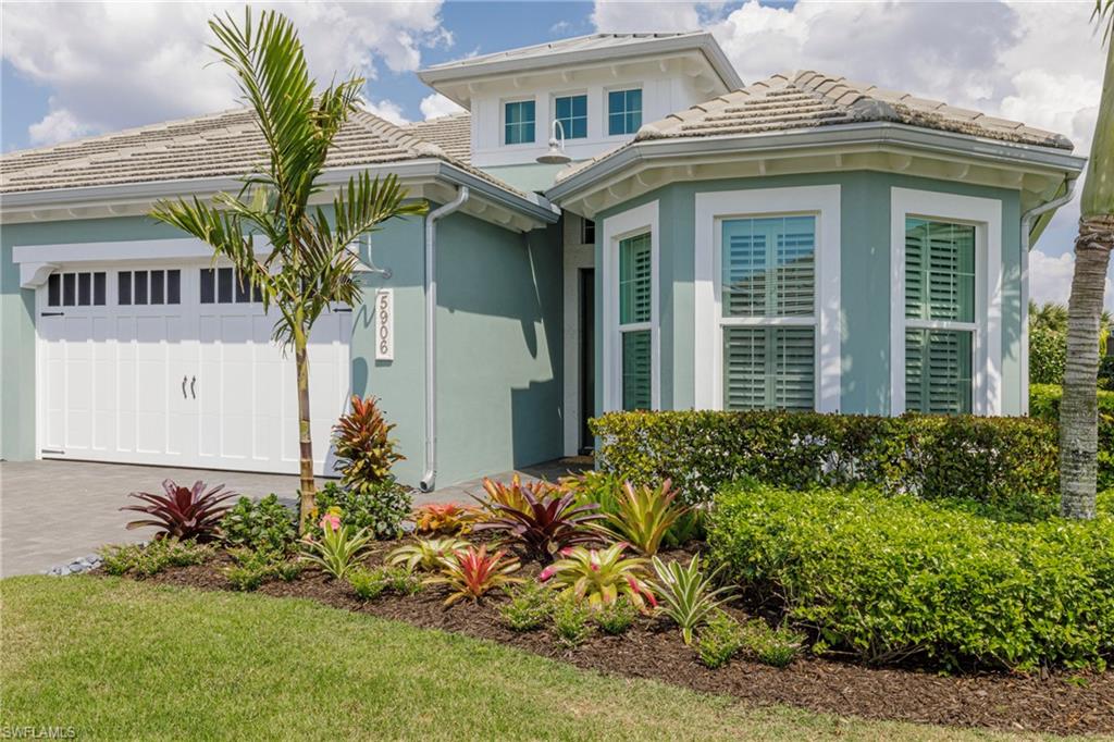 5906 Haiti Drive Naples, FL 34113 - Photo 1 of 44 a front view of a house with garden