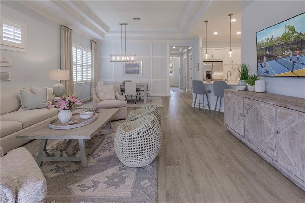 5906 Haiti Drive Naples, FL 34113 - Photo 12 of 44 a dining room with furniture and wooden floor