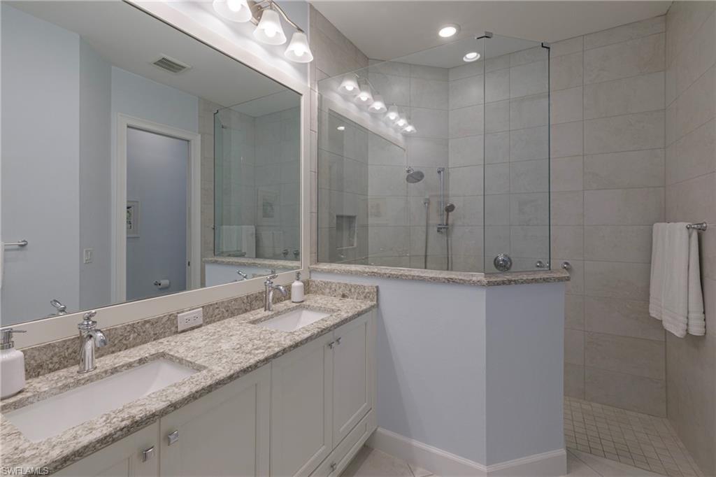 5906 Haiti Drive Naples, FL 34113 - Photo 17 of 44 a bathroom with a granite countertop sink and a mirror