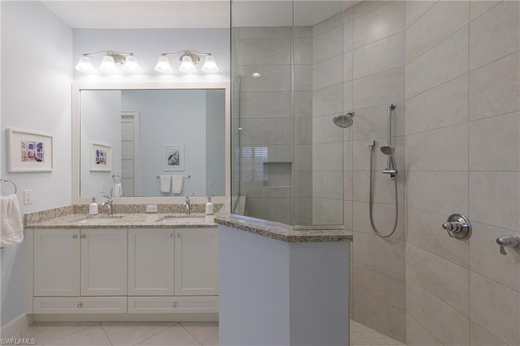 5906 Haiti Drive Naples, FL 34113 - Photo 18 of 44 a bathroom with a granite countertop shower sink and mirror