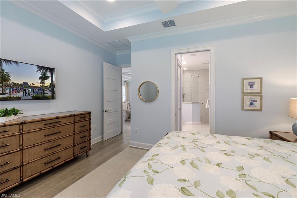 5906 Haiti Drive Naples, FL 34113 - Photo 19 of 44 a bedroom with a bed and a dresser