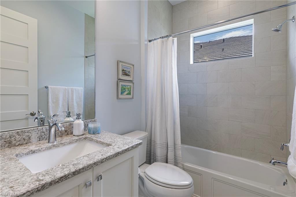 5906 Haiti Drive Naples, FL 34113 - Photo 24 of 44 a bathroom with a granite countertop sink toilet and shower