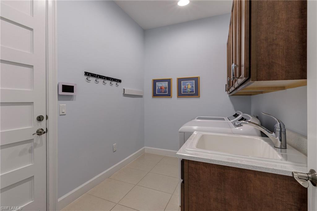 5906 Haiti Drive Naples, FL 34113 - Photo 26 of 44 a bathroom with a sink and cabinets
