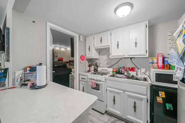 a kitchen that has a lot of cabinets a stove and a refrigerator
