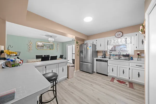 a kitchen with appliances cabinets and a sink