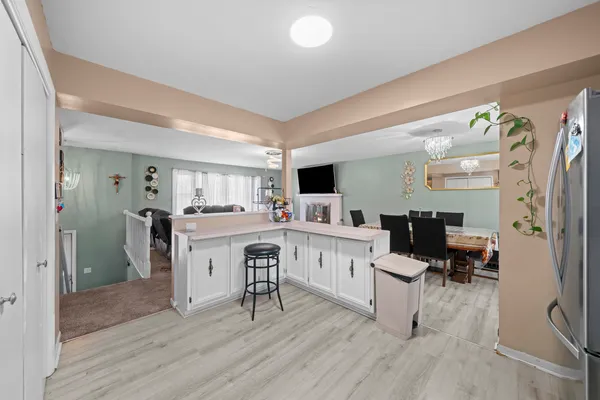 a kitchen with a sink cabinets and wooden floor