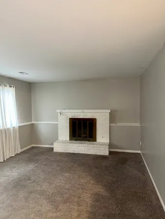 a view of an empty room with a fireplace