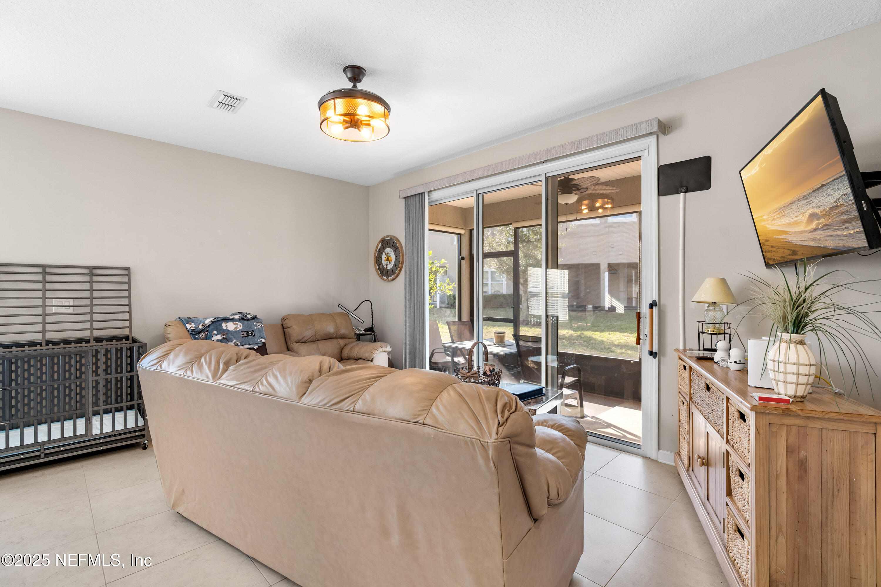 3165 Chestnut Ridge Way Orange Park, FL 32065 - Photo 11 of 35 a living room with furniture and a flat screen tv
