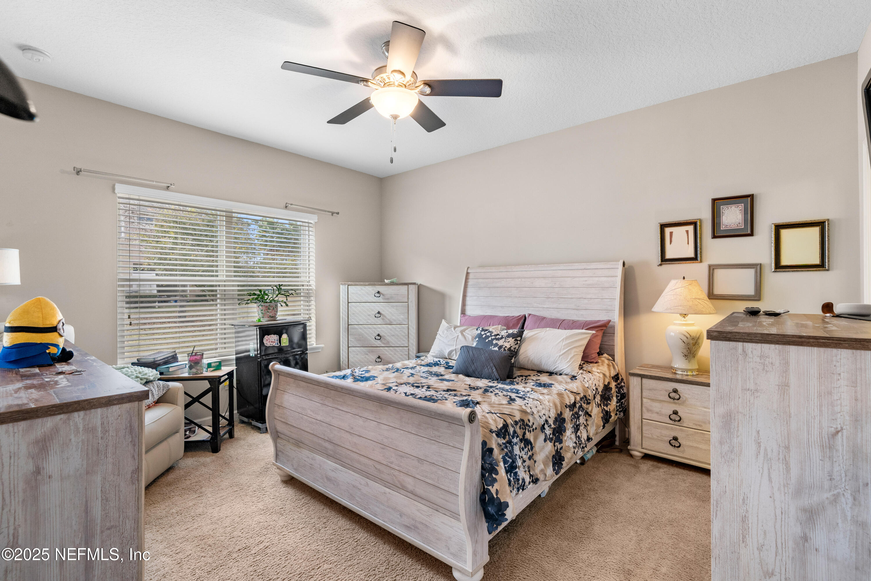 3165 Chestnut Ridge Way Orange Park, FL 32065 - Photo 12 of 35 a bedroom with a bed a couch and a large window