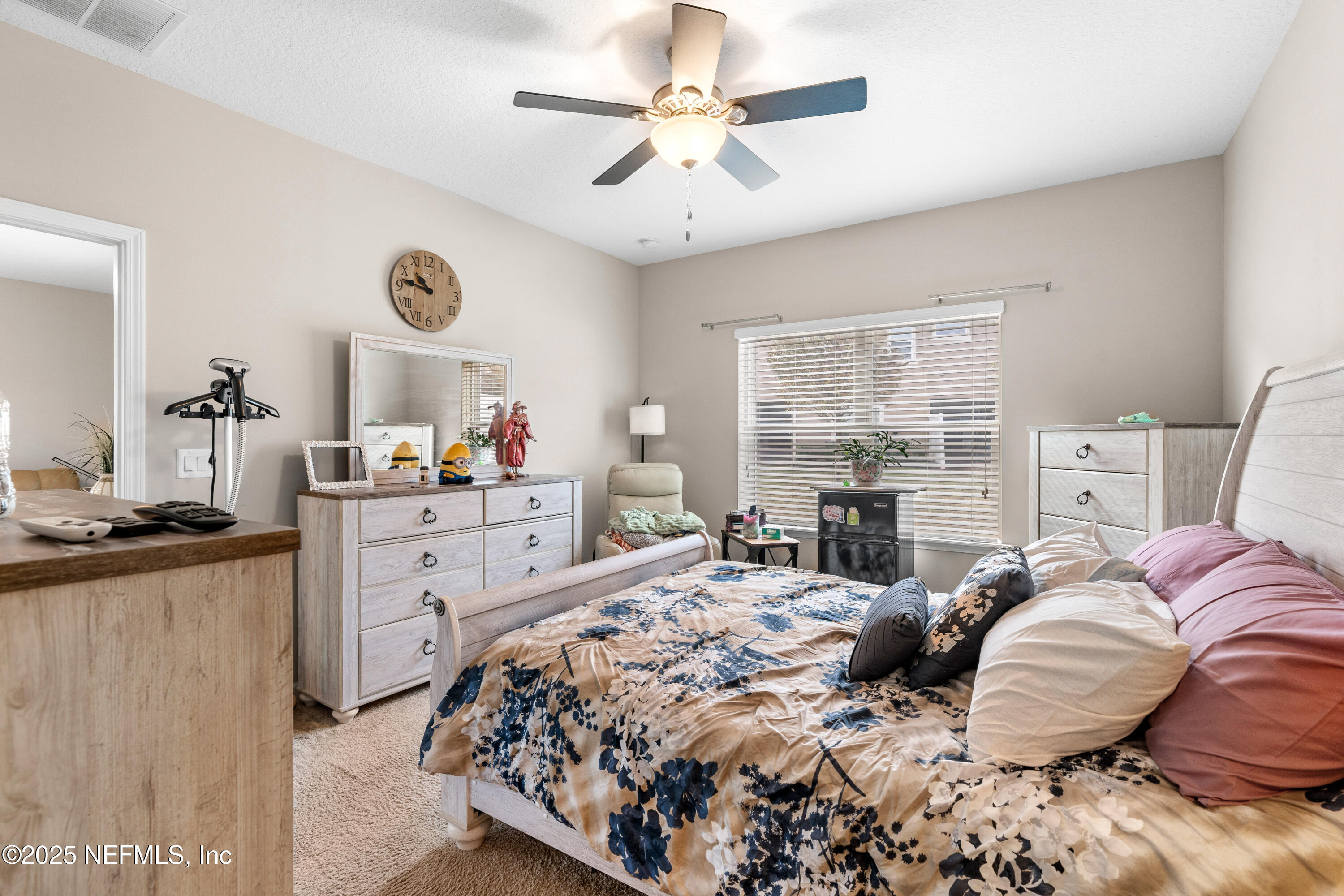 3165 Chestnut Ridge Way Orange Park, FL 32065 - Photo 13 of 35 a bedroom with a bed and a chandelier
