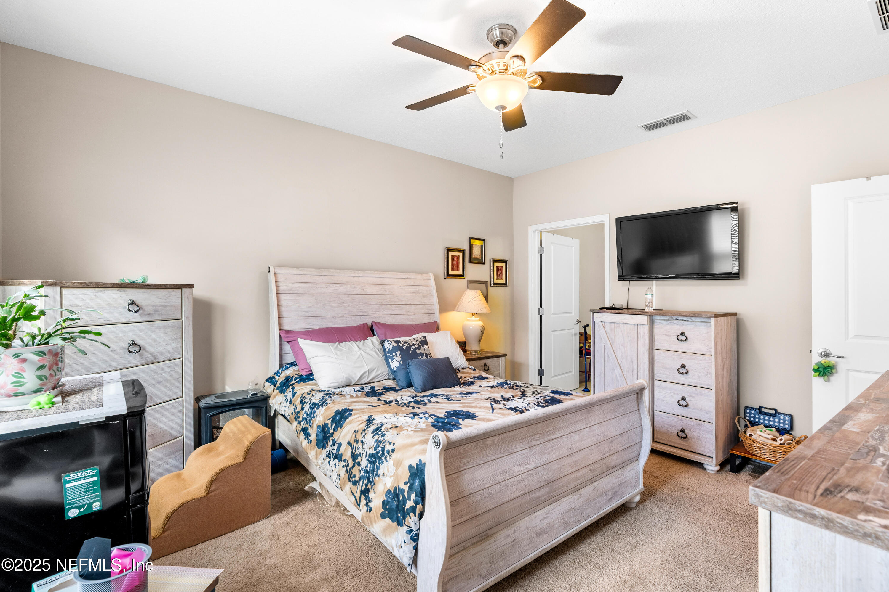 3165 Chestnut Ridge Way Orange Park, FL 32065 - Photo 14 of 35 a living room with furniture and a flat screen tv