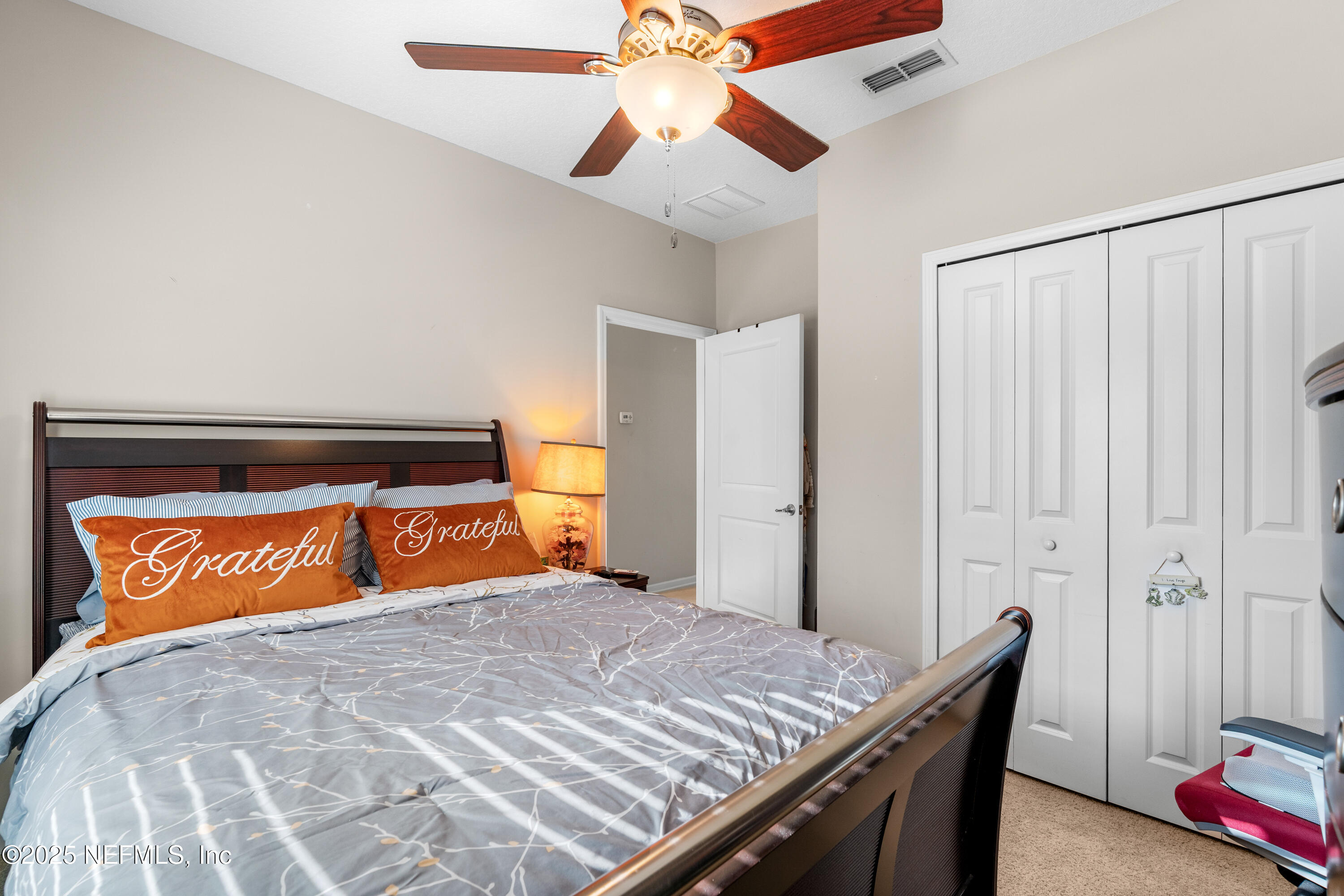 3165 Chestnut Ridge Way Orange Park, FL 32065 - Photo 21 of 35 a bedroom with a bed and a dresser