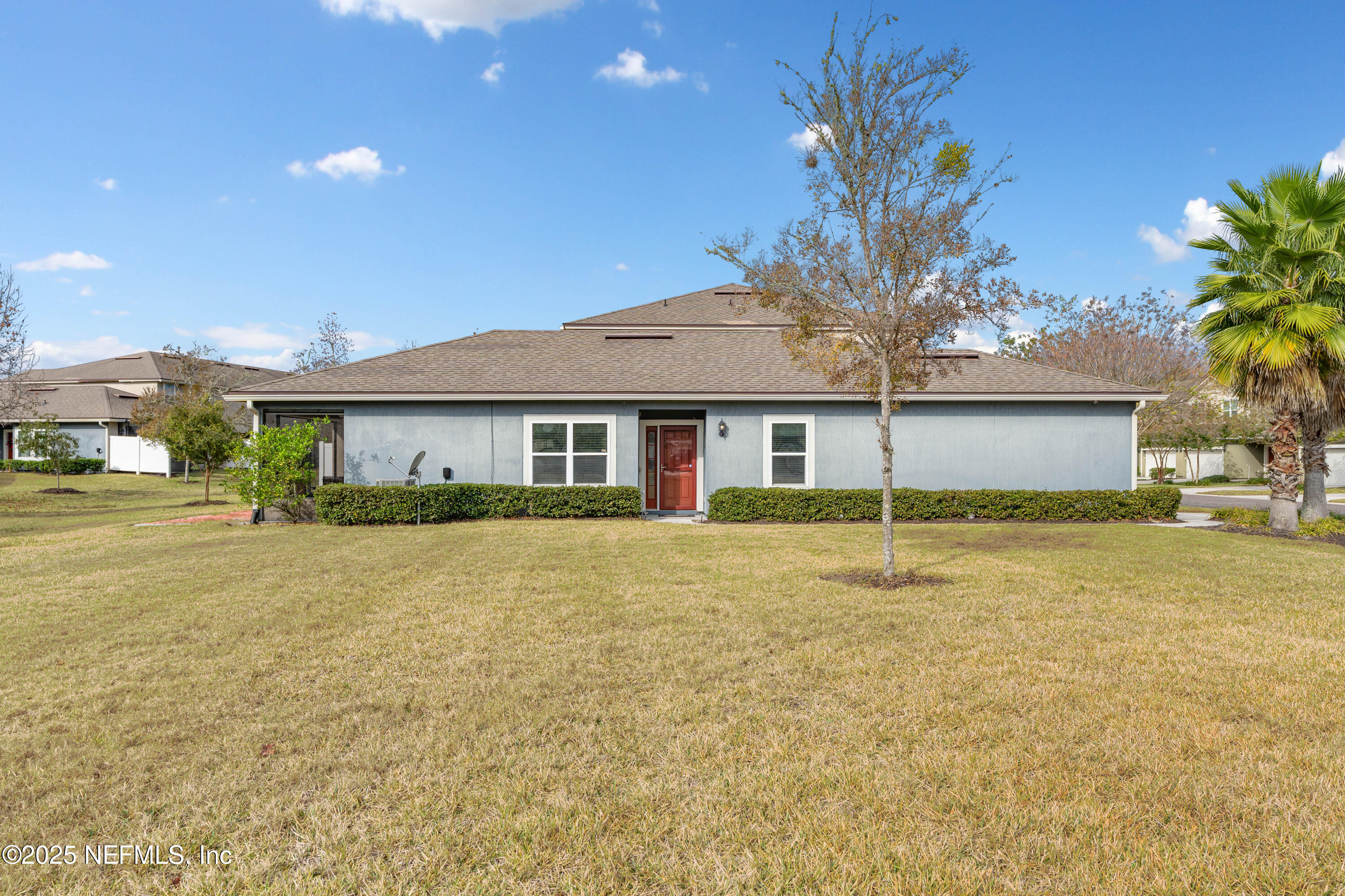 3165 Chestnut Ridge Way Orange Park, FL 32065 - Photo 25 of 35 a front view of a house with a garden and trees