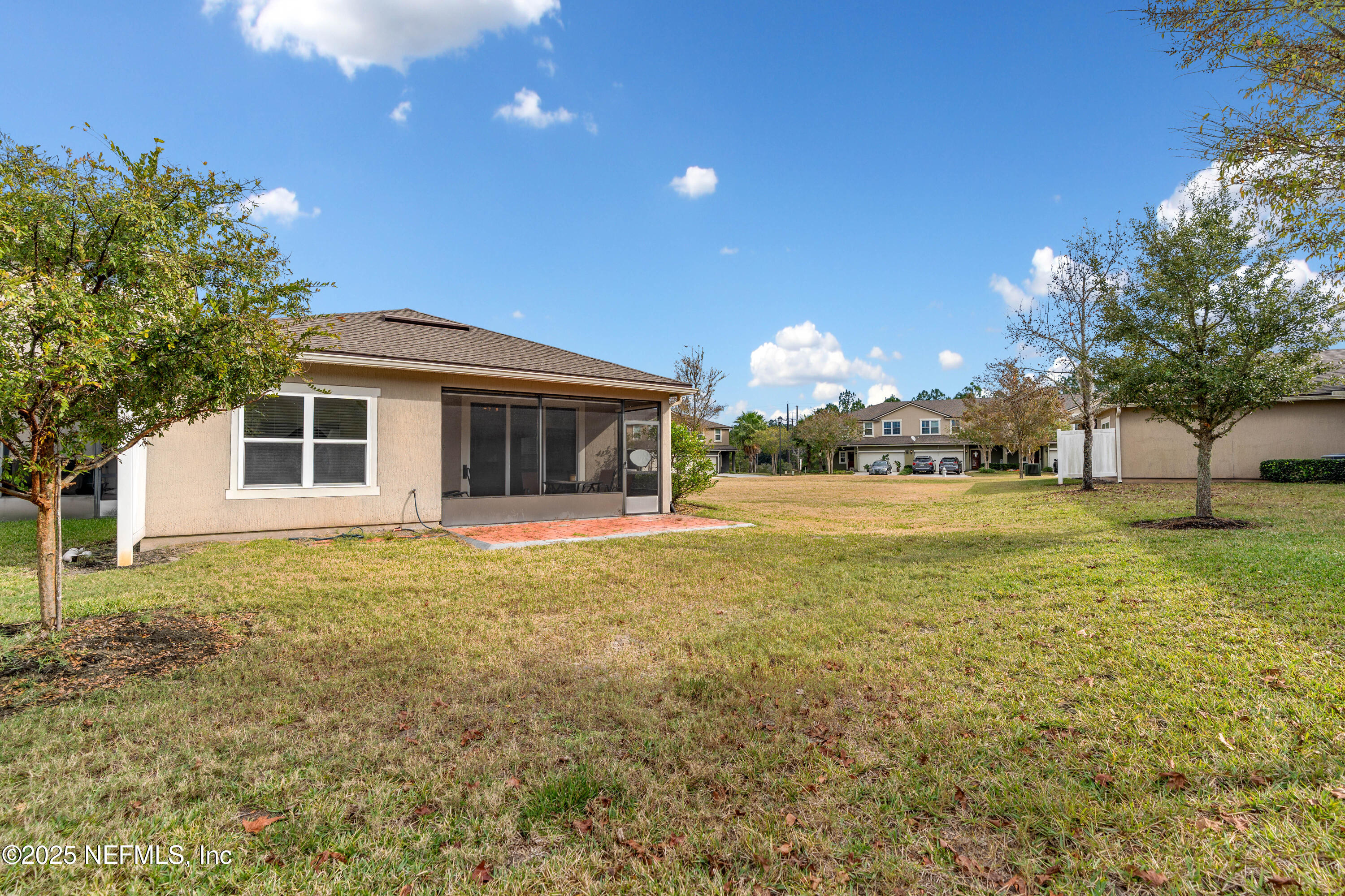 3165 Chestnut Ridge Way Orange Park, FL 32065 - Photo 27 of 35 a backyard of a house with table and chairs