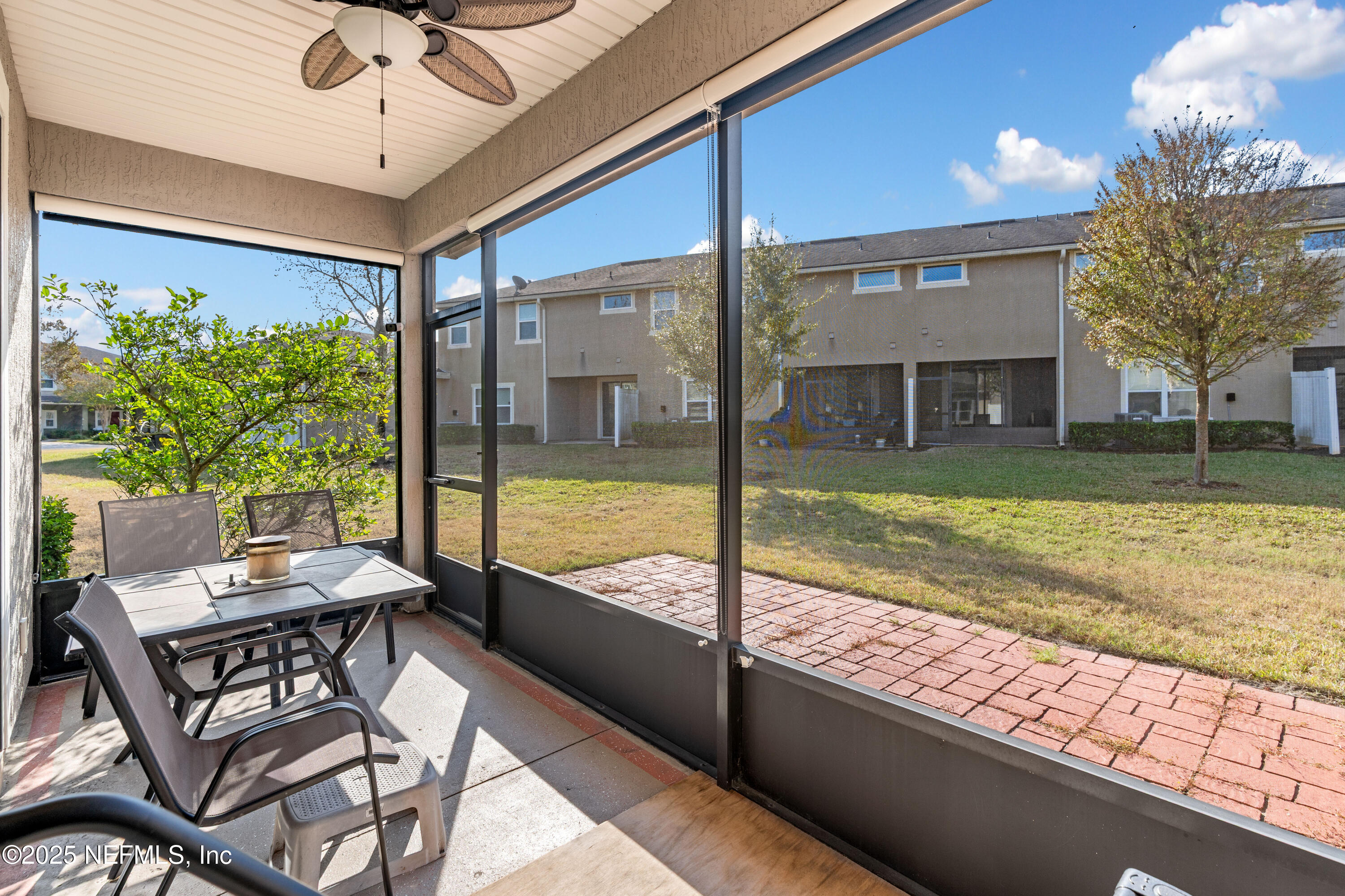 3165 Chestnut Ridge Way Orange Park, FL 32065 - Photo 30 of 35 a view of a patio with a table chairs and a backyard