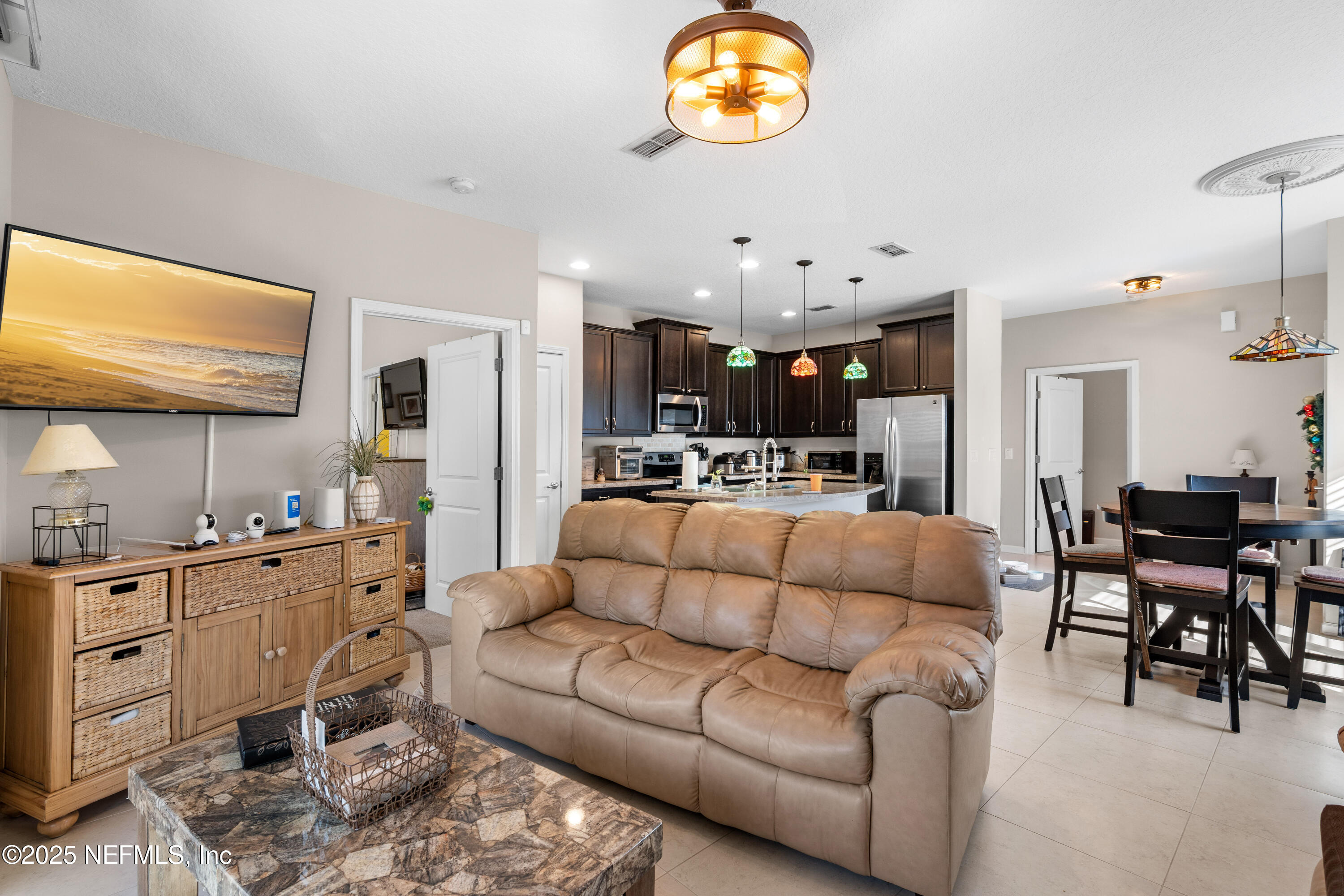 3165 Chestnut Ridge Way Orange Park, FL 32065 - Photo 10 of 35 a living room with furniture kitchen view and a flat screen tv