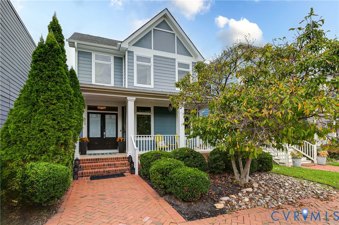 a front view of a house with a garden