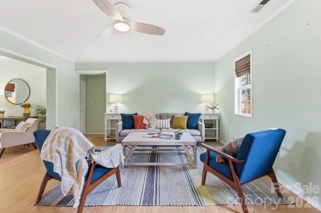 a living room with furniture and wooden floor