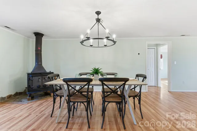 a view of a dining room with furniture wooden floor and chandelier