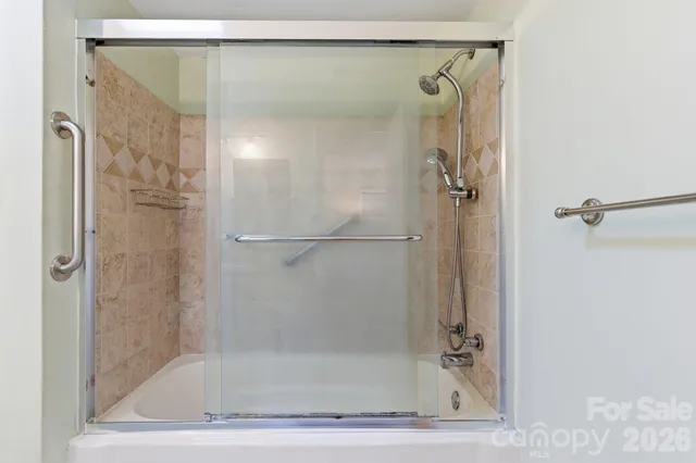 a bathroom with a glass shower door