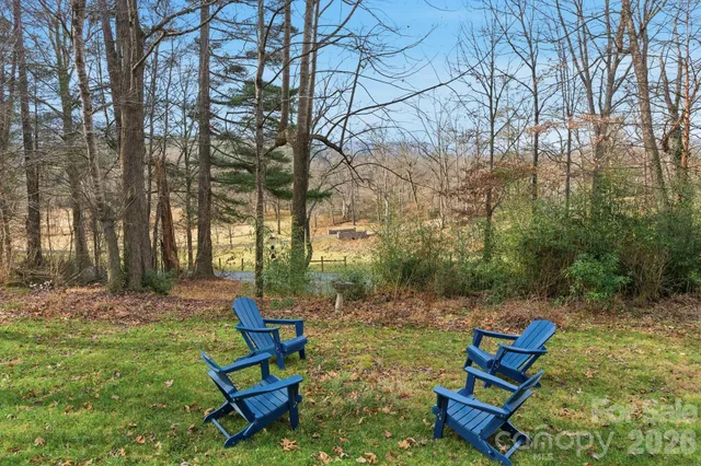 a view of a backyard with chairs