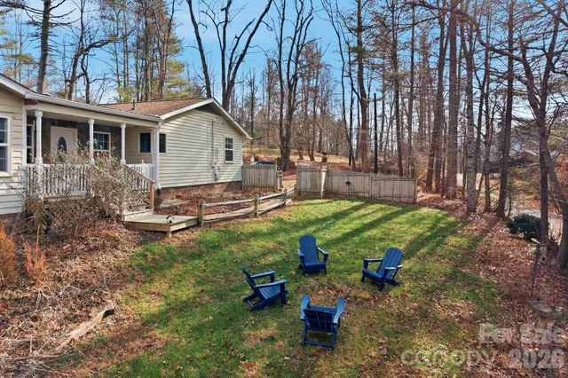 a view of a backyard with table and chairs and a fire pit