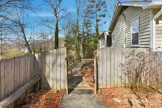a view of a house with a door and wooden fence