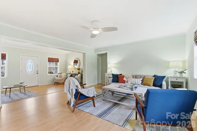 a living room with furniture and a wooden floor