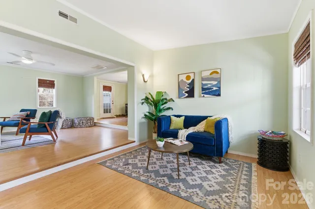 a living room with furniture and a potted plant