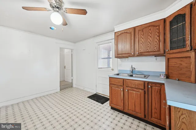 a kitchen with a sink a stove and cabinets