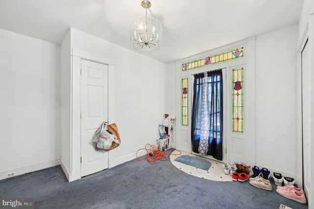 a bedroom with a bed and a curtain