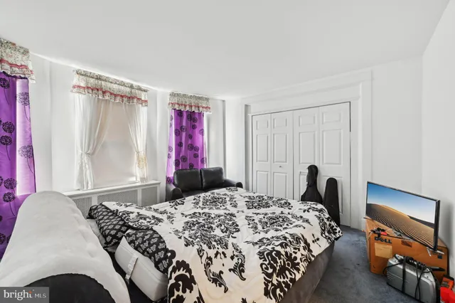 an empty room with windows and entrance