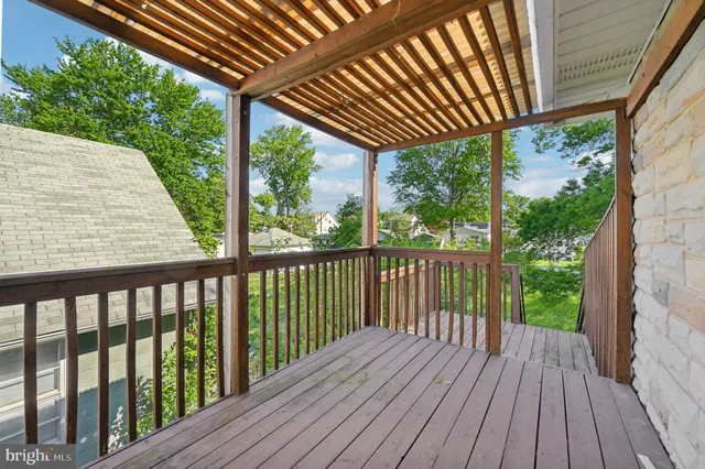 a view of a backyard with table and chairs and potted plants and large trees