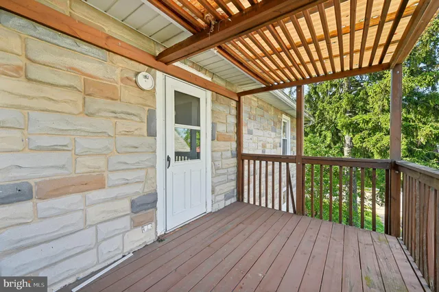 a view of a house with a backyard and sitting area