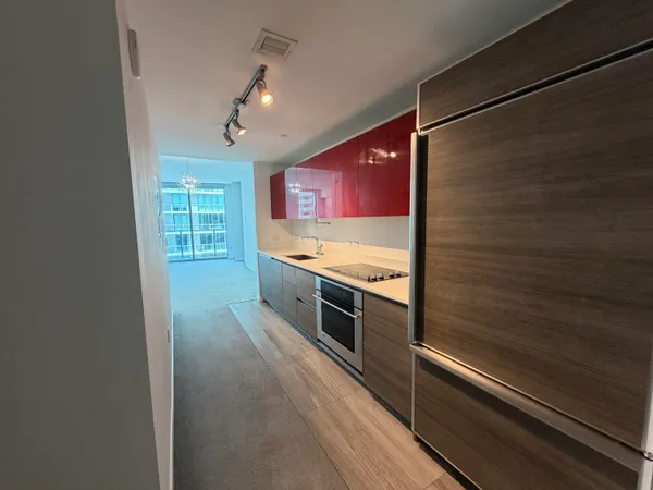 a large kitchen with stainless steel appliances granite countertop a stove and a refrigerator