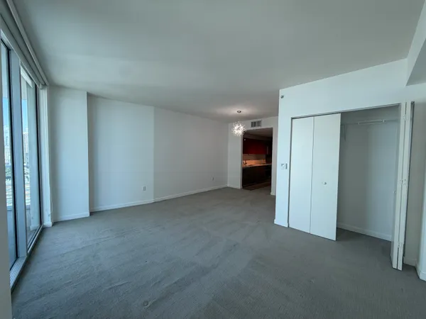 a view of an empty room and a window