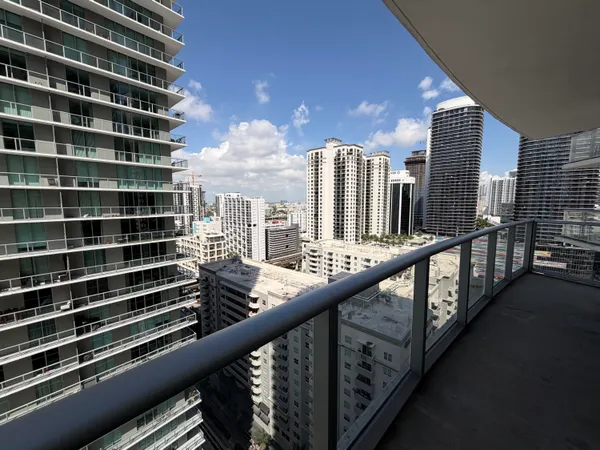 a view of a balcony with a couple of buildings