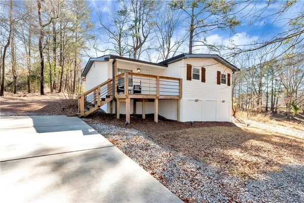 a view of a white house with a yard covered in snow