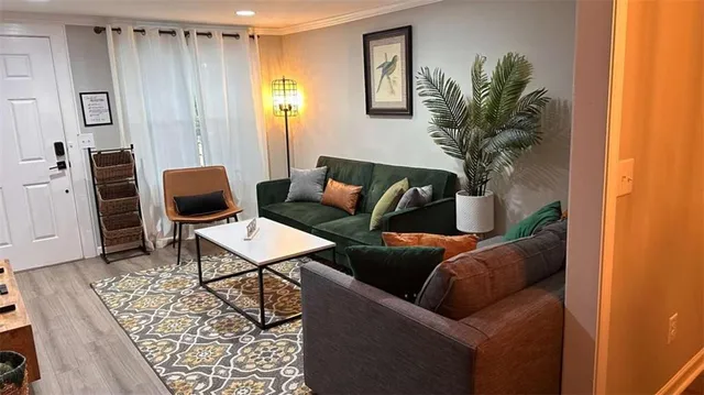 a living room with furniture and a potted plant