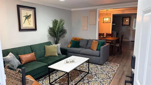 a living room with furniture and a potted plant