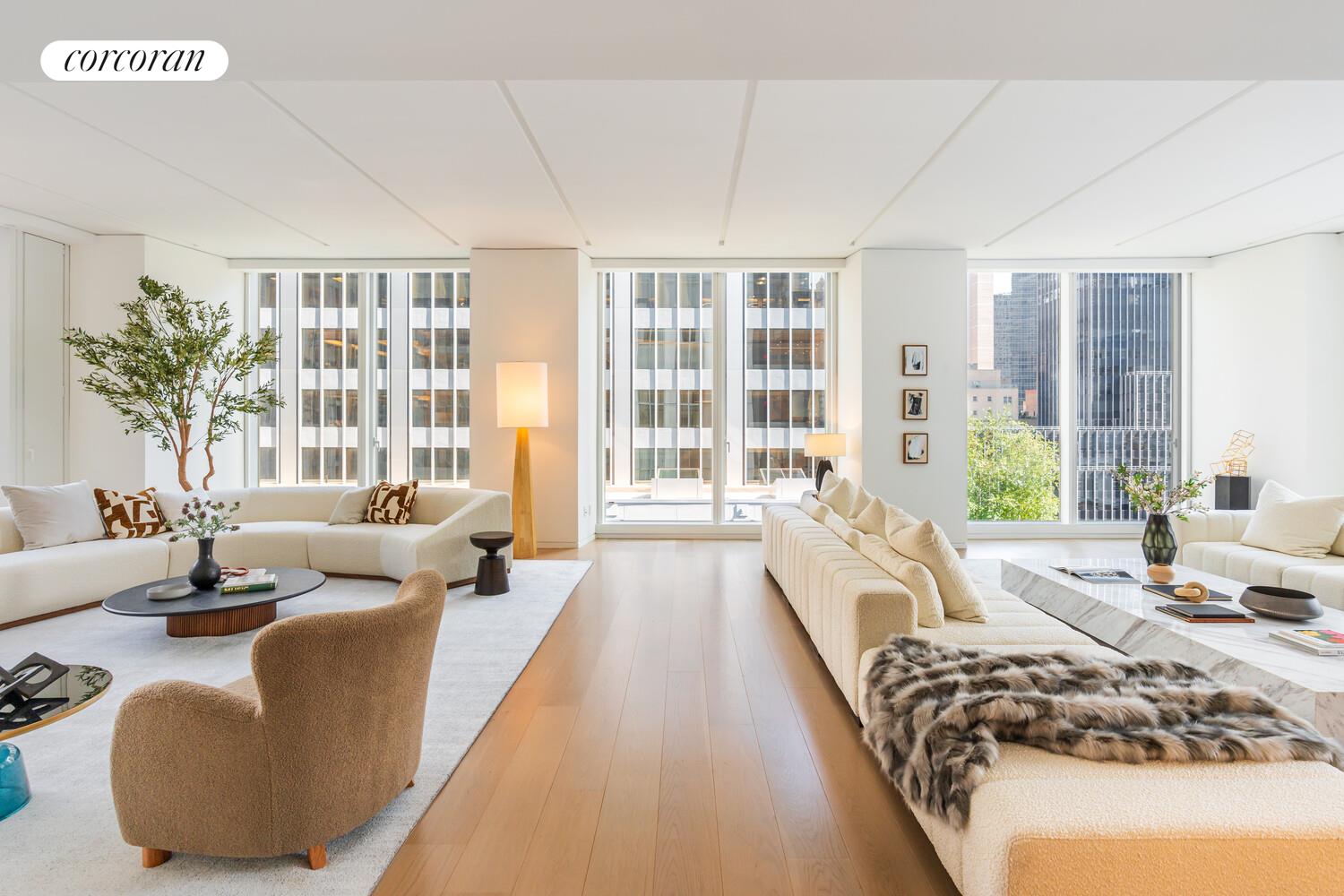 100 East 53rd Street, Unit 10A Manhattan, NY 10022 - Photo 9 of 35 a spacious bedroom with a bed couch and a large window